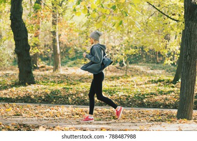 Woman Running In The Autumn Park