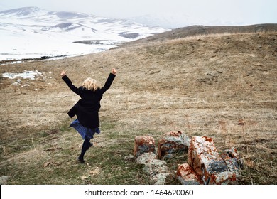 Woman Running Away In The Snow Landscape