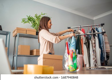 Woman Running Business From Home. Shipping shopping online, young start up small business owner packing cardboard box at workplace. Online selling or e-commerce.
