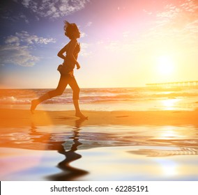 Woman running by the ocean beach at sunset - Powered by Shutterstock