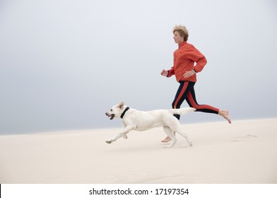 Woman Running With Dog On The Dune