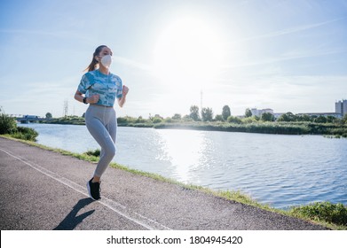 Woman Running With Face Mask, Doing Exercises Outdoors