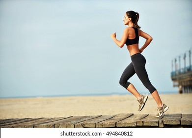 Woman Running On Santa Monica Beach Boardwalk