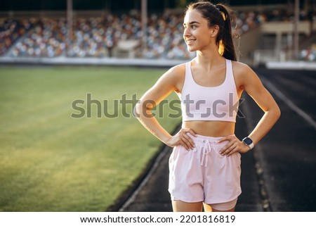 Woman running on the stadium running track