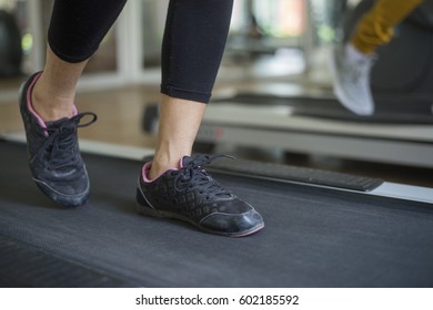 Woman Running On Treadmill In Gym