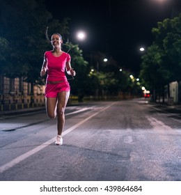 Woman Running Outdoors On The Night. High ISO.