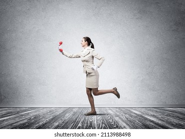 Woman Running In Room With Vintage Red Phone. Call Center Operator In White Business Suit Posing With Telephone. Hotline Telemarketing And Communication. Professional Business Assistance And Support