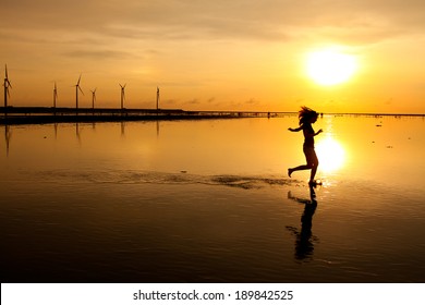 Woman Running At Sunset Silhouette