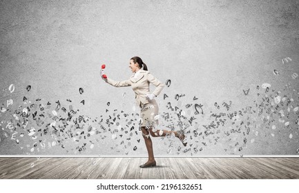 Woman Running With Vintage Red Phone. Young Female Secretary With Telephone And Flying Various Letters Around. Hotline Telemarketing And Communication. Professional Business Assistance