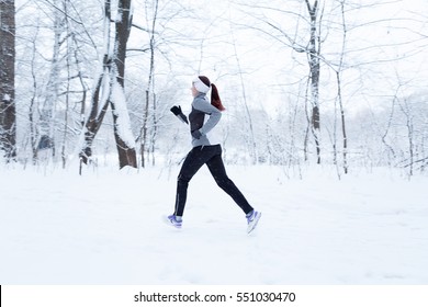 Woman Running In Winter Woods