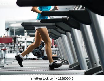 woman runs on a treadmill, exercise in the sport club