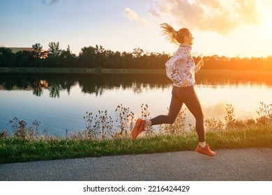 Woman runs in the park on autumn morning. Healthy lifestyle concept, people go in sports outdoors. Silhouette family at sunset. Fresh air. Health care, authenticity, sense of balance and calmness. - Powered by Shutterstock