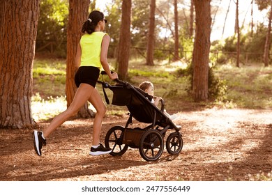 A woman runs with a stroller in the forest. - Powered by Shutterstock