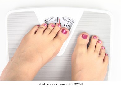 Woman' s feet on bathroom scale. Diet Concept