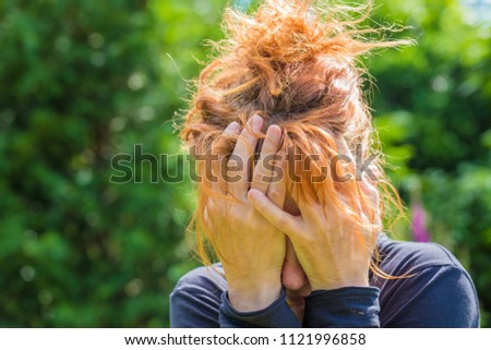 Similar – a desperate woman holding her hands in front of her face