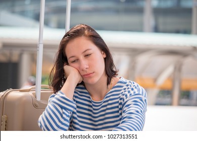 Woman Is So Sad She Missed Her Flight. A Missed Connection Flight Can Leave The Passenger Stranded At The Airport For Hours On End.