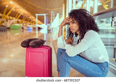 Woman sad and unhappy at the airport with flight canceled