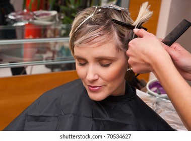 Woman In Salon Making New Hair Style