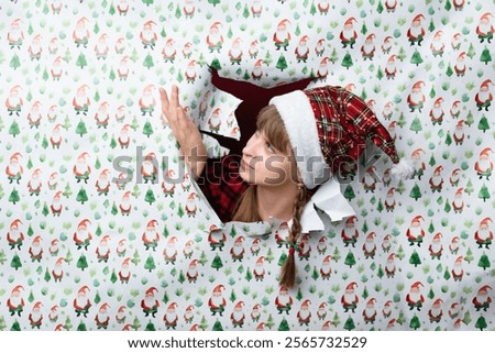 Similar – Image, Stock Photo Woman peeking through Christmas wrapping paper, festive mood