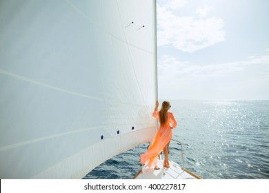 woman in sarong yachting white sails cruise luxury travel vacation
