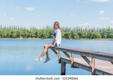 Woman Sat By Lake