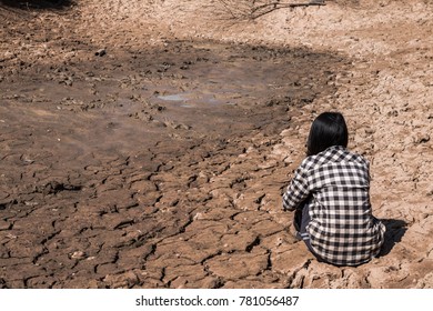 The Woman Sat On A Barren Ground With Despair.