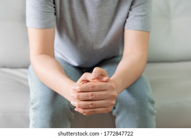 Woman Sat On Sofa And Held His Hand To Pray