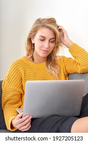 Woman Sat On A Sofa Using A Laptop Computer