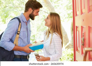 Woman Saying Goodbye To Man Leaving Home With Packed Lunch