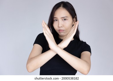 woman saying no with rejecting hand gesture and negative facial expression