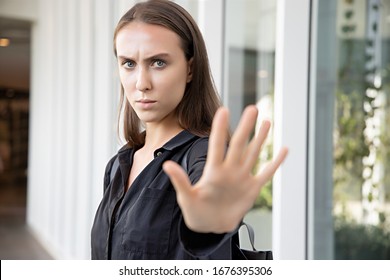 Woman Saying No Or Stop With Hand Gesture; Caucasian White Woman Puts Her Hand Up For Stop, Halt, No Way, Rejection, Turning Down, Disapproval, Broken Deal; Russian Caucasian Young Adult Woman Model