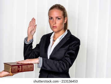 a woman says as a witness in court in a lawsuit. is sworn in and swears on the bible.