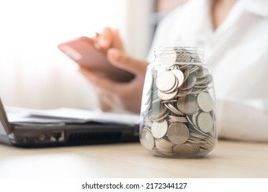 Woman Scan Bills To Make Online Payment Mobile Banking Conept. Working Hard To Save More Money Coins In Jar And Pay For The Bills.