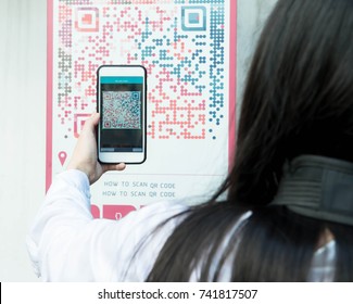 Woman Scan QR Code With Smart Phone.