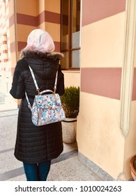 Woman With Scarf Posing In Front Of Old Library With Floral Fancy Backpack