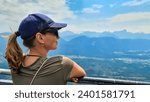 Woman with scenic view from the viewing platform red wall (Rote Wand) in the alpine garden of Dobratsch, Villacher Alps, Carinthia, Austria, Europe. Massive cliff overlooking the mountains of alps