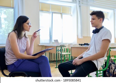 Woman school psychologist talking and helping student, male teenager. Mental health of adolescents, psychology, social issues, professional help of counselor