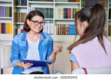 Woman school psychologist, teacher, social worker, mentor working with teenage girl