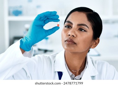 Woman, scientist and holding pill for medicine research, inspection and innovation in laboratory. Science, medical doctor and capsule drugs for healthcare cure, development and study pharma chemical - Powered by Shutterstock