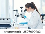 Woman, scientist and microscope at laboratory for bacteria with medical research, investigation and development. Male person, lab coat and serious with testing for virus, disease and illness