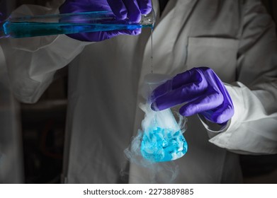 A woman scientist performing Organic reaction under fuming condition in a laboratory. Fume, radioactive, fluorescence. A copy space black background. Organic medicinal chemistry laboratory.