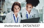 Woman, scientist and team with laptop for research, new discovery or breakthrough at lab. Female person or biologists working together on biotechnology for collaboration or results at laboratory