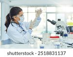 Woman, scientist and test tube with thinking at laboratory, assessment or liquid drug development. Person, chemistry and safety glasses with mpox research, medicine and mask for vaccine at pharma job