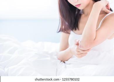 Woman Scratching Her Arm And Elbow Because Of Dry Skin At Home