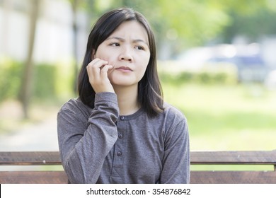 Woman Scratching Her Face At Park