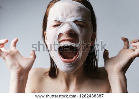   woman screaming on face cosmetic mask                             
