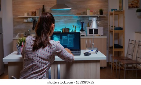 Woman scrolling programming security hacking code data late at night on laptop. Programmer writing a dangerous malware for cyber attacks using performance device during midnight. - Powered by Shutterstock