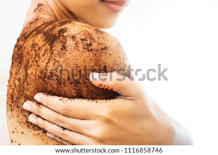 Woman is scrubbing body with coffee.