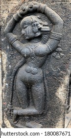 Woman Sculpture Posed Dance Steps. Bas Relief Sculpture Carved In The Stone Walls At Shiva Temple In Tamil Nadu