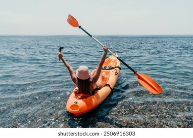 Woman sea kayak. Happy smiling woman paddling in kayak on ocean. Calm sea water and horizon in background. Active lifestyle at sea. Summer vacation. - Powered by Shutterstock